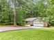 Charming single-story home with a lush, tree-filled yard and attached two-car garage at 845 Creek Trail Northwest Nw Trl, Kennesaw, GA 30144