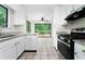 An inviting kitchen showcases stainless steel appliances, white cabinets, granite counters, and a view to the backyard deck at 845 Creek Trail Northwest Nw Trl, Kennesaw, GA 30144