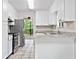 A spacious kitchen is equipped with stainless steel appliances, white cabinets, and granite countertops at 845 Creek Trail Northwest Nw Trl, Kennesaw, GA 30144