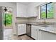 Charming kitchen with white cabinetry, granite countertops, stainless steel dishwasher, and views of the outdoors at 845 Creek Trail Northwest Nw Trl, Kennesaw, GA 30144