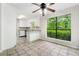 Eat-in kitchen features tiled flooring, white cabinets, and a view of the outdoors at 845 Creek Trail Northwest Nw Trl, Kennesaw, GA 30144