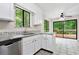 Bright kitchen featuring white cabinets, granite counters, stainless steel appliances, and a view of the outdoors at 845 Creek Trail Northwest Nw Trl, Kennesaw, GA 30144