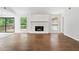 Spacious living room featuring a stone fireplace, sleek wood flooring, and large windows at 845 Creek Trail Northwest Nw Trl, Kennesaw, GA 30144