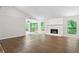 Large open concept living room, featuring a white fireplace and sliding glass door to deck at 845 Creek Trail Northwest Nw Trl, Kennesaw, GA 30144