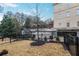 Fenced backyard provides space for outdoor activities with mature trees, shrubs, and open lawn at 3667 Peachtree Ne Rd # 16, Atlanta, GA 30319