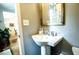 Charming powder room featuring a pedestal sink and a decorative mirror at 40 Olde Ivy Ne Sq, Atlanta, GA 30342