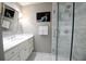 Modern bathroom featuring a vanity, mirror and a glass enclosed shower with marble tile at 40 Olde Ivy Ne Sq, Atlanta, GA 30342