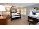 Traditional bedroom features a four-poster bed, writing desk, and a neutral color palette at 40 Olde Ivy Ne Sq, Atlanta, GA 30342