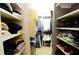 Well-organized walk-in closet with shelving and hanging space for clothes and shoes at 40 Olde Ivy Ne Sq, Atlanta, GA 30342