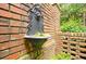 The outdoor brick wall features a decorative metal water fountain and detailed brickwork at 40 Olde Ivy Ne Sq, Atlanta, GA 30342
