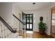 Welcoming foyer with staircase, a black front door, and hardwood floors at 40 Olde Ivy Ne Sq, Atlanta, GA 30342