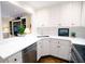 Well-lit kitchen with white cabinetry, stainless steel appliances, and open access to the living room at 40 Olde Ivy Ne Sq, Atlanta, GA 30342