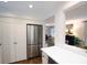 Kitchen with stainless steel refrigerator and white cabinets and an open access to the living room at 40 Olde Ivy Ne Sq, Atlanta, GA 30342