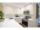 Bright kitchen with white cabinets, stainless steel appliances, and a large counter space at 40 Olde Ivy Ne Sq, Atlanta, GA 30342
