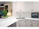 Bright kitchen features stainless steel appliances, white cabinets, and convenient breakfast bar at 40 Olde Ivy Ne Sq, Atlanta, GA 30342