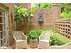 Charming brick patio features chairs, table, fountain, and lush landscaping at 40 Olde Ivy Ne Sq, Atlanta, GA 30342