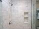 Elegant marble shower with a built-in niche for storage and modern fixtures at 40 Olde Ivy Ne Sq, Atlanta, GA 30342