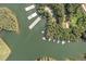 Scenic aerial view of lake with docks, boathouses and surrounding lush green trees and water access at 451 Wilderness Camp Rd, White, GA 30184