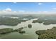 Breathtaking aerial view highlighting the lake, islands, and surrounding lush landscape at 451 Wilderness Camp Rd, White, GA 30184