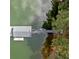 Aerial view showing a wooden dock with access to water, and is surrounded by lush green trees at 451 Wilderness Camp Rd, White, GA 30184