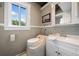 Neat bathroom featuring a white vanity, sink, and a unique toilet system, complemented by a bright window at 451 Wilderness Camp Rd, White, GA 30184