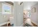 View of a well lit modern bathroom and hallway leading to a small kitchen and outdoor access at 451 Wilderness Camp Rd, White, GA 30184