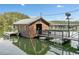 Exterior shot of a charming boathouse featuring a wooden exterior, deck, and waterfront access for easy boat docking at 451 Wilderness Camp Rd, White, GA 30184