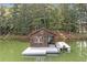 Charming lake house with a wooden exterior, complete with a cozy front deck and a private boat dock at 451 Wilderness Camp Rd, White, GA 30184