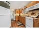 Well-equipped kitchen with wooden cabinets, modern appliances, and a view of the lake and entryway at 451 Wilderness Camp Rd, White, GA 30184