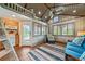 Cozy living area featuring wood paneling, waterfront views, and a ladder leading to a loft at 451 Wilderness Camp Rd, White, GA 30184