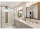 Bright bathroom with glass-enclosed shower, dual sinks, and gray vanity at 884 Mayfield Rd, Milton, GA 30009