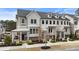 Attractive townhome showcasing a stylish exterior with multiple windows and manicured greenery at 884 Mayfield Rd, Milton, GA 30009