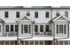 A row of townhomes featuring private balconies, garage parking, and neutral exteriors at 884 Mayfield Rd, Milton, GA 30009