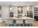 Kitchen featuring an island with seating, stainless steel appliances, and neutral color palette at 884 Mayfield Rd, Milton, GA 30009