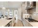 Bright kitchen with stainless steel appliances, island with seating, and ample cabinet space at 884 Mayfield Rd, Milton, GA 30009