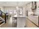 Open kitchen with stone countertops, stainless steel appliances, and access to the dining room at 884 Mayfield Rd, Milton, GA 30009