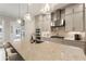Bright kitchen with stainless steel appliances, island with seating, and stylish pendant lighting at 884 Mayfield Rd, Milton, GA 30009