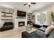 Living room featuring a modern fireplace, sleek décor, and hardwood floors at 884 Mayfield Rd, Milton, GA 30009
