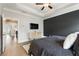 Spacious main bedroom featuring a tray ceiling, a wall-mounted television, and hardwood flooring at 884 Mayfield Rd, Milton, GA 30009