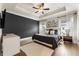 Elegant main bedroom with tray ceiling, fan, hardwood floors, and serene gray and white decor at 884 Mayfield Rd, Milton, GA 30009