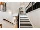Staircase with black railing leading to another floor with a decorative shelf space at 884 Mayfield Rd, Milton, GA 30009