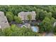 Aerial view of an apartment complex and pool surrounded by lush greenery and ample parking at 123 Ashford Cir, Atlanta, GA 30338