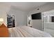 Bedroom view shows a large TV, walk in closet, and doorway to a bathroom with a double vanity at 123 Ashford Cir, Atlanta, GA 30338