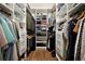 Spacious walk-in closet with custom shelving and storage solutions to organize clothes and accessories at 123 Ashford Cir, Atlanta, GA 30338