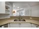Kitchen sink area with neutral countertops and a view into the living room at 123 Ashford Cir, Atlanta, GA 30338