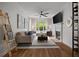 Bright living room features a ceiling fan, fireplace, and large windows with natural light at 123 Ashford Cir, Atlanta, GA 30338