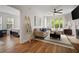 Inviting living room with large windows, a cozy sofa, fireplace, and a view into the main bedroom at 123 Ashford Cir, Atlanta, GA 30338