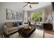 Comfortable living room with neutral tones, stylish decor, and views of lush greenery outside at 123 Ashford Cir, Atlanta, GA 30338