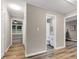 Hallway view showcasing wood-look floors and seamless transition to a bedroom and bathroom at 2068 Verbena Nw St, Atlanta, GA 30314
