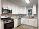 Kitchen featuring stainless steel appliances and white cabinets at 2068 Verbena Nw St, Atlanta, GA 30314